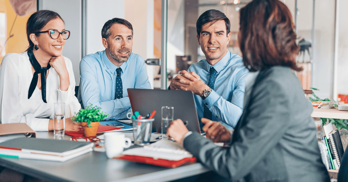Hospital management team meeting around a boardroom table
